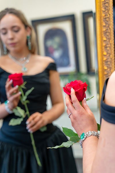 portrait of a woman in front of a rose